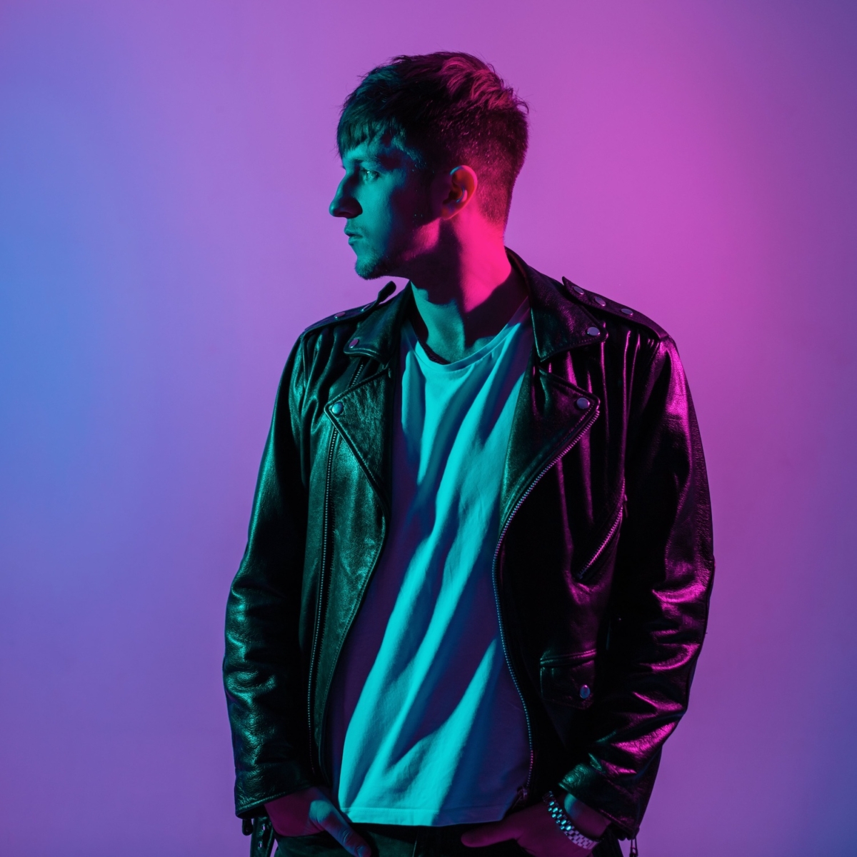 Mann in Lederjacke mit Neonlicht Porträt seitlich